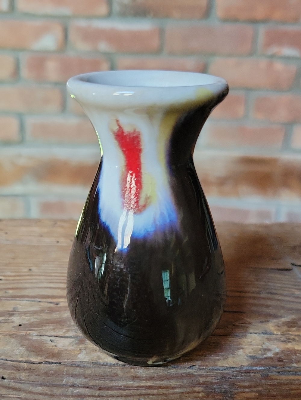 MCM German Ceramic Pottery Bud Vase in Black with Red, Cream, an Blue Drip Glaze
